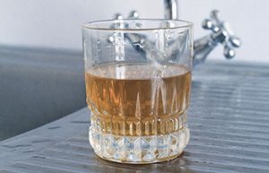 polluted well water in a drinking water glass image