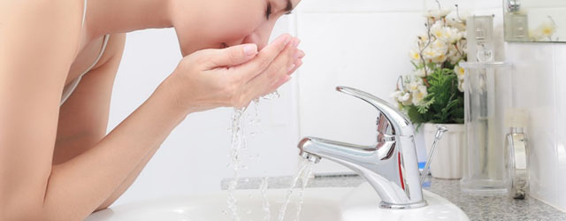 Well water treatment FAQs image of lady washing her face.